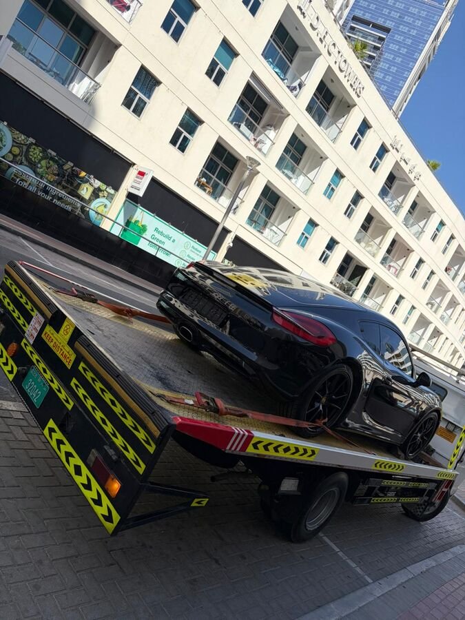 Black Porsche on transport truck