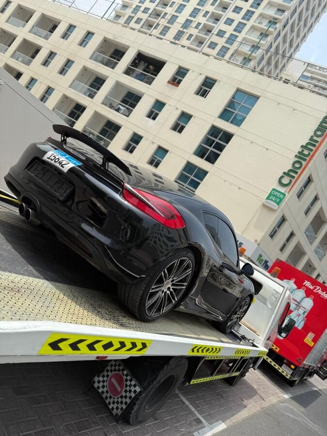 Black Porsche on flatbed truck