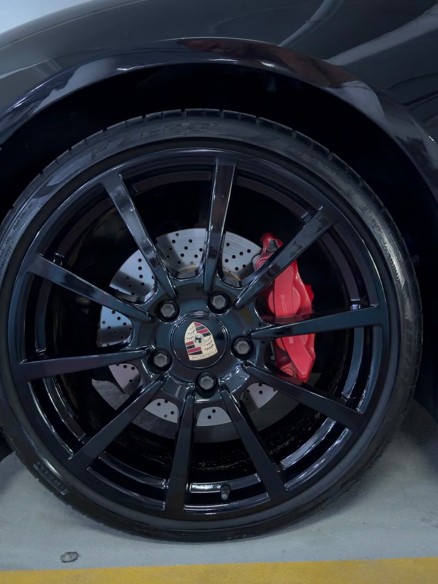 Porsche Cayman GTS black, parking garage
