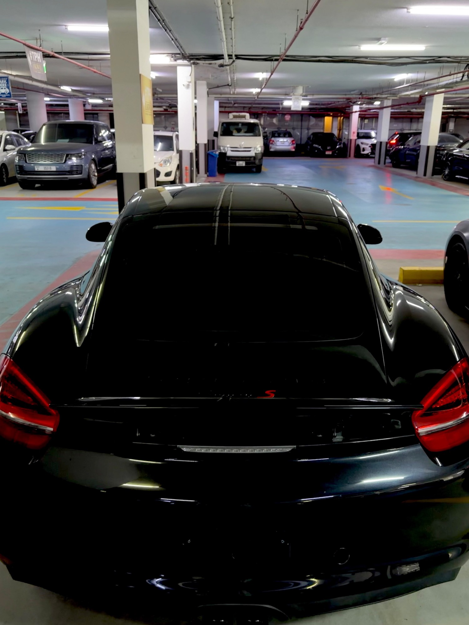 Porsche Cayman GTS black, side profile bright