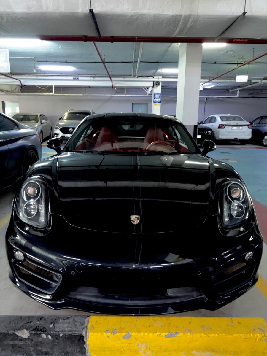 Porsche Cayman GTS black, side angle two