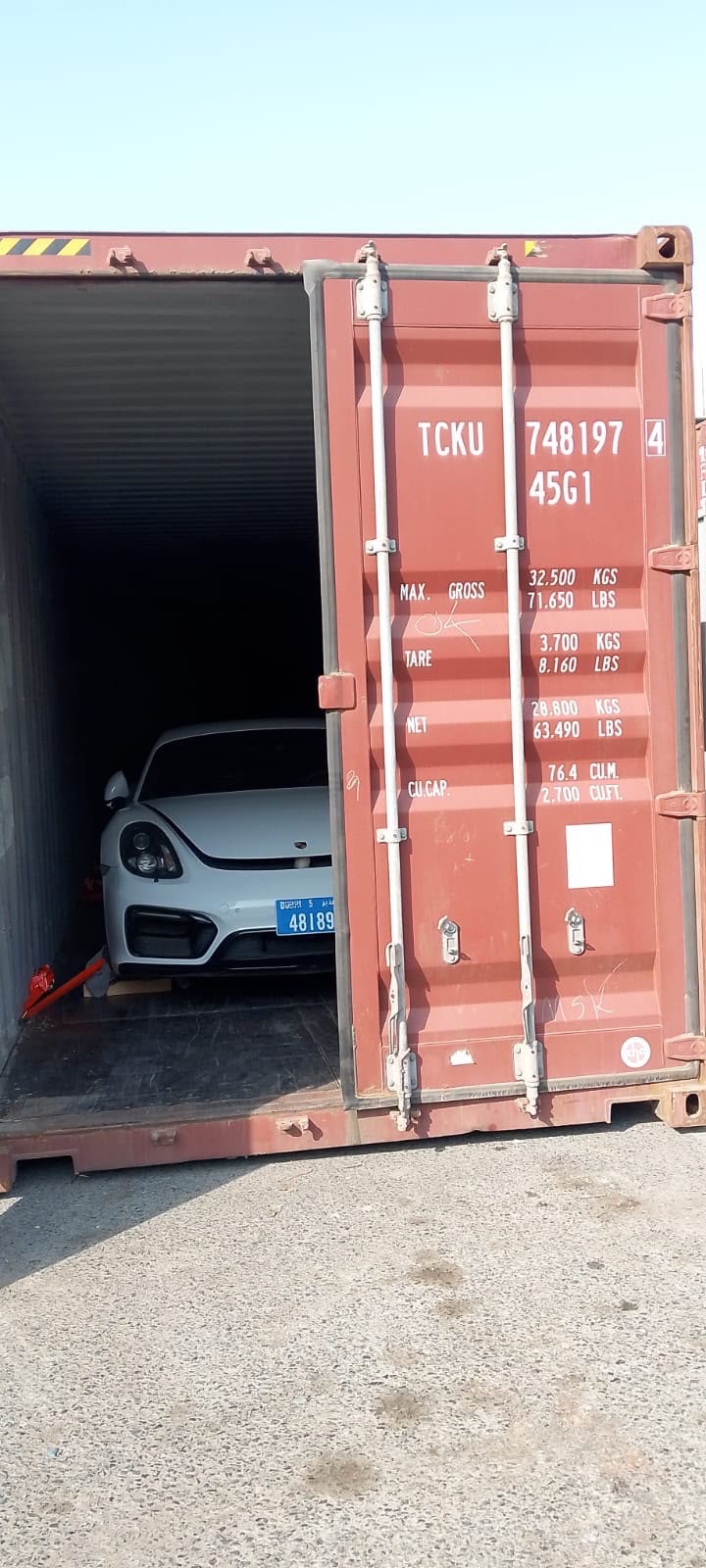Porsche, white, in transit to Europe